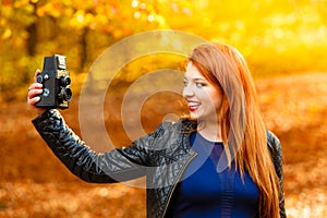 Woman taking photo picture with old camera outdoor