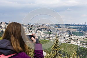 Woman taking photograph with smartphone at enjoying view of Jerusalem Photograph on the phone Old City of Jerusalem