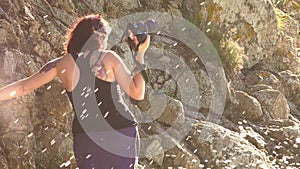 Woman taking a photos with dslr camera outdoors, on the beach