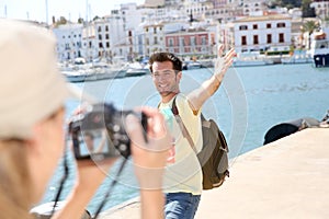 Woman taking photos of her boyfriend on holidays