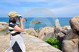 Woman taking photos at the Hin Ta Hin Yai