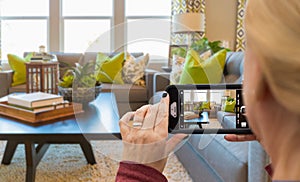 Woman Taking Photos of A Living Room in Model Home with Her Smart Phone photo