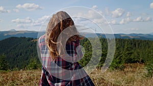 Woman taking photos of mountains on photo camera. Photographer looking pictures