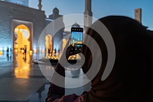 Woman taking photos with a smart phone of a mosque at sunset | Abu Dhabi Sheik Zayed Mosque | Beautiful islamic architecture | Tou