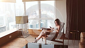 Woman Taking Photos and talking by the phone In a Skyscraper