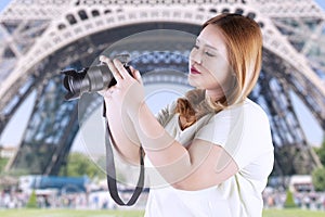 Woman taking picture at eiffel tower