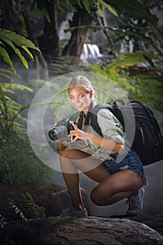 Woman is taking picture in the jungle