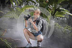 Woman is taking picture in the jungle
