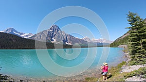 Woman taking picture with phone at Banff National Park in summer