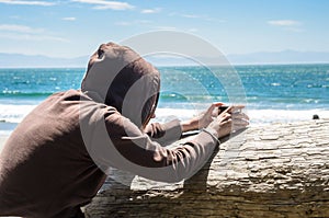 Woman Taking Picture with a Smartphone on a Beach on a Sunny Day