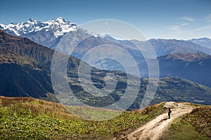 Woman taking pictures of a beautiful mountain landscape