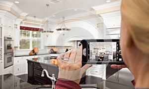 Woman Taking Pictures of A Custom Kitchen with Her Smart Phone