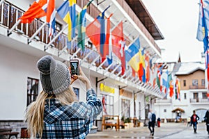 Woman taking pictures in European travel. Solo travel and using technology concept