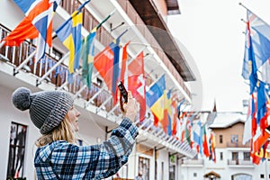 woman taking pictures in European travel. Solo travel and using technology concept