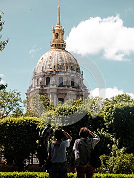 Woman taking pictures of the famous The Dome in Les Invalides in Paris