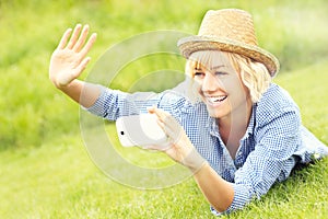 Woman taking pictures on grass