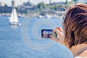 Woman Taking Pictures with her Mobile Phone