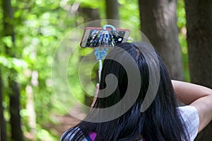 A woman taking pictures with her smartphone