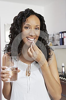Woman Taking Pill With Water
