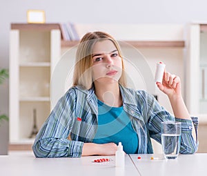 Woman taking pills to cope with pain