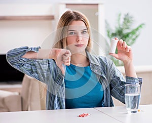 Woman taking pills to cope with pain