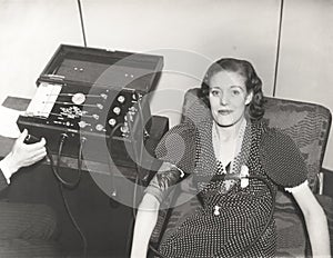 Woman taking a polygraph test photo