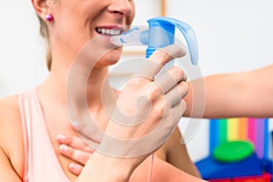 Woman taking pulmonary function test with mouthpiece in her hand