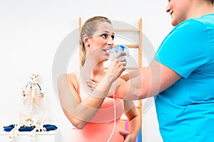 Woman taking pulmonary function test with mouthpiece in her hand