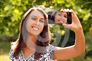 Woman Taking Self Portrait with Phone Camera