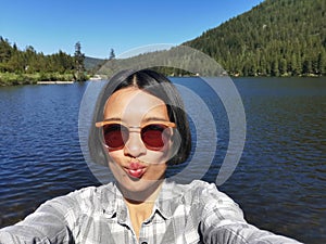 Woman taking a selfie at Chain lake, British Columbia Canada