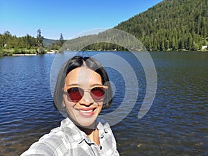 Woman taking a selfie at Chain lake, British Columbia Canada