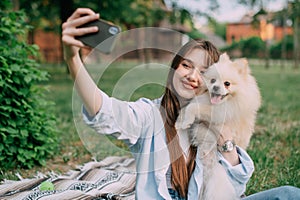 Woman taking selfie with dog