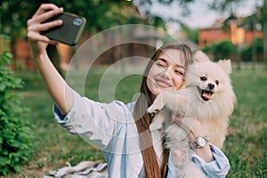 Woman taking selfie with dog