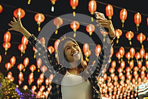 Woman taking selfie at lantern festival