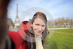 Woman taking selfie near the Eiffel tower