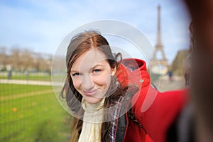 Woman taking selfie near the Eiffel tower