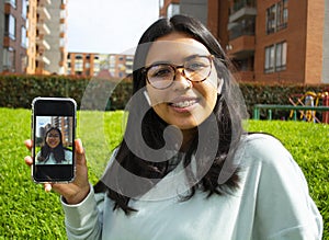 Woman taking a selfie photo with phone smiling