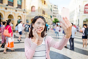 Woman taking selfie in Senado Square of Macao photo