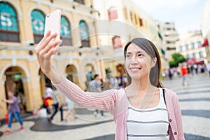 Woman taking selfie in Senado Square of Macao photo
