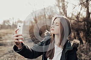 Woman taking selfie on smartphone
