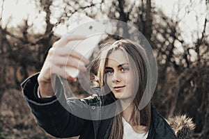 Woman taking selfie on smartphone