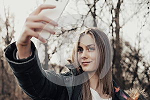 Woman taking selfie on smartphone