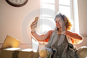 Woman Taking Selfie While Trying Clothes At Home