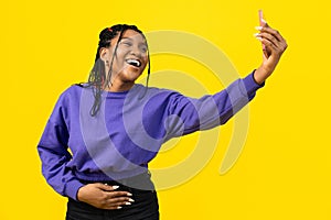 Woman Taking Selfie on Yellow Background