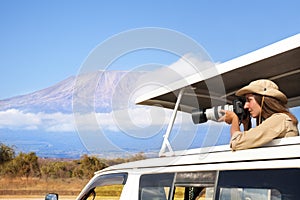 Woman taking shots during Kenyan safari game drive