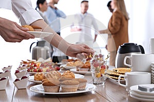 Woman taking snack during coffee break, closeup