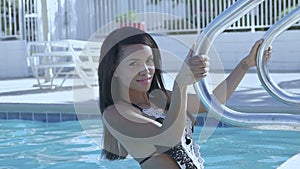 Woman taking sunbath by the pool