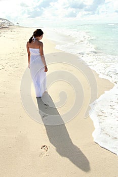 Woman taking a walk at the beach and relaxing