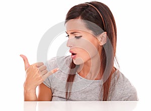 Woman with talk gesture looking to her hand