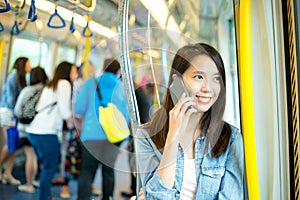 Woman talk to cellphone in train compartment